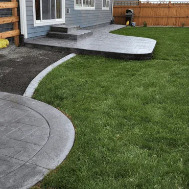 Custom-installed backyard patios for a homeowner in Loveland, CO, featuring two separate concrete patio areas for outdoor living