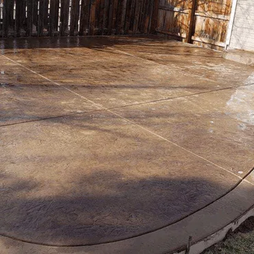 Stamped concrete patio showcasing modern design trends in Colorado, featuring a durable and stylish surface with earthy tones.