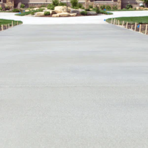 A freshly replaced, spacious, and beautifully finished concrete driveway in Loveland, CO, showcasing expert craftsmanship by Hugo’s Concrete.