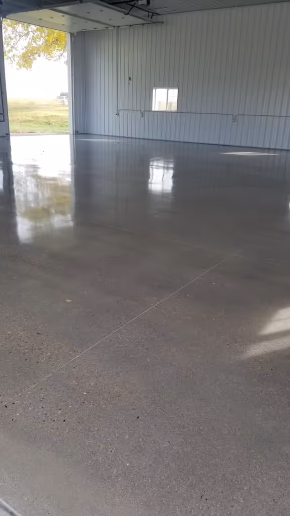 Polished concrete flooring in a spacious indoor area, showcasing a smooth, reflective surface in Windsor, CO