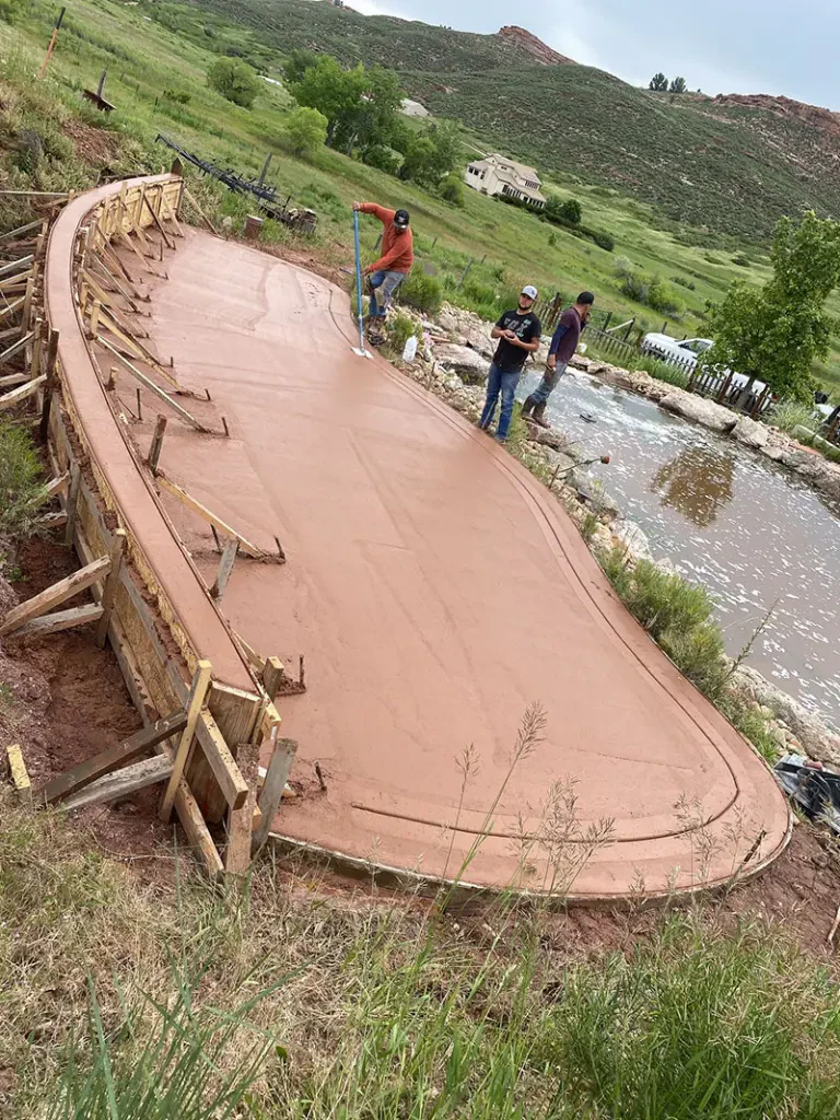 Curved colored concrete patio installed in Loveland by Hugo’s Concrete