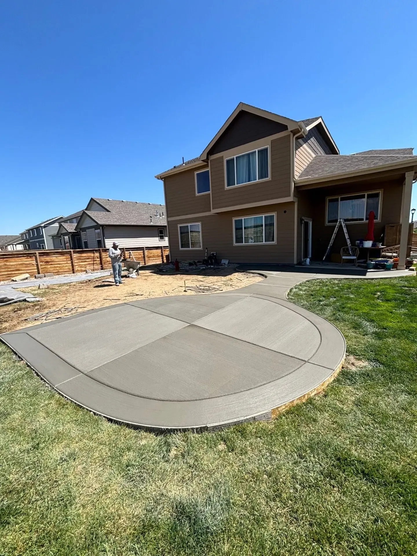 New broom-finished concrete walkway and stamped patio installed by Hugo’s Concrete in Greeley, CO