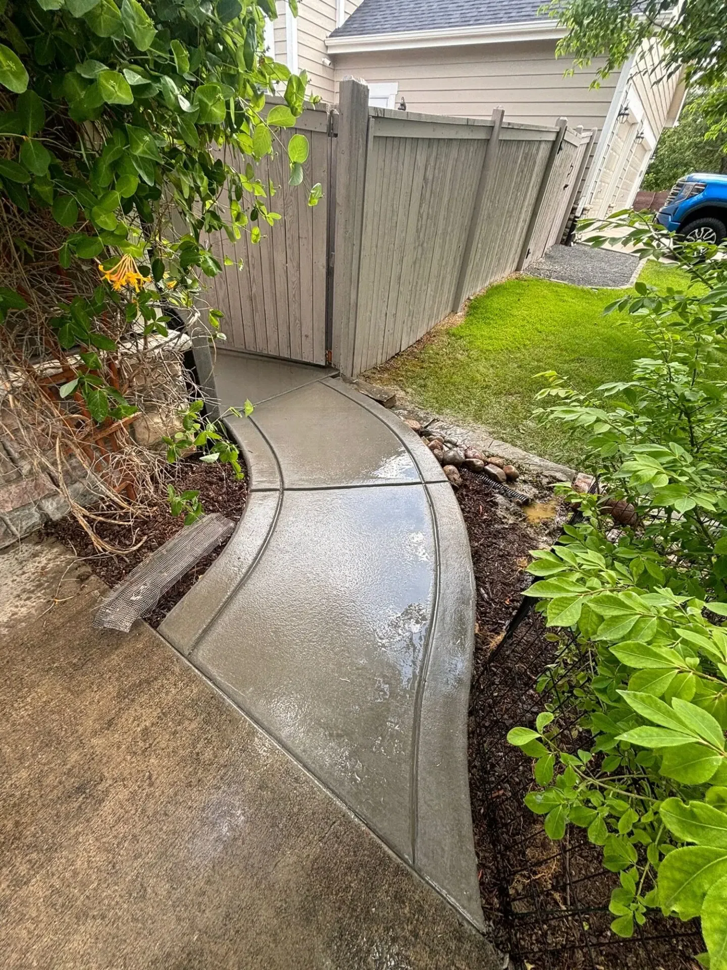 Completed broom finished concrete walkway leading to backyard – Aruba Dr, Fort Collins, installed by Hugo’s Concrete