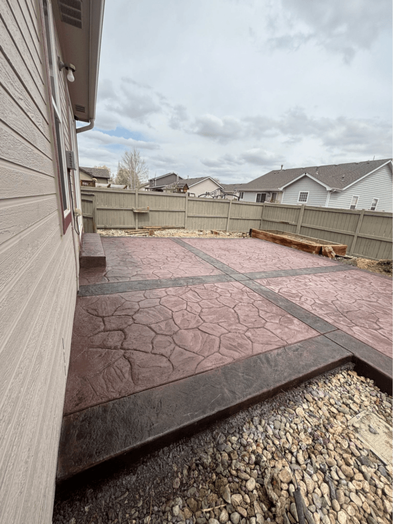 Stamped and colored concrete patio installed on Indian Village Dr in Wellington, Colorado, featuring custom texture and premium finish