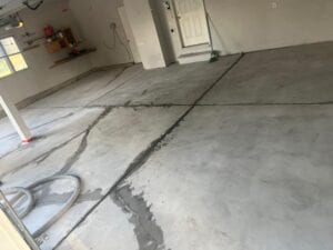 Garage floor prepped for epoxy with patching, grinding, and repairs completed before coating in Windsor, CO