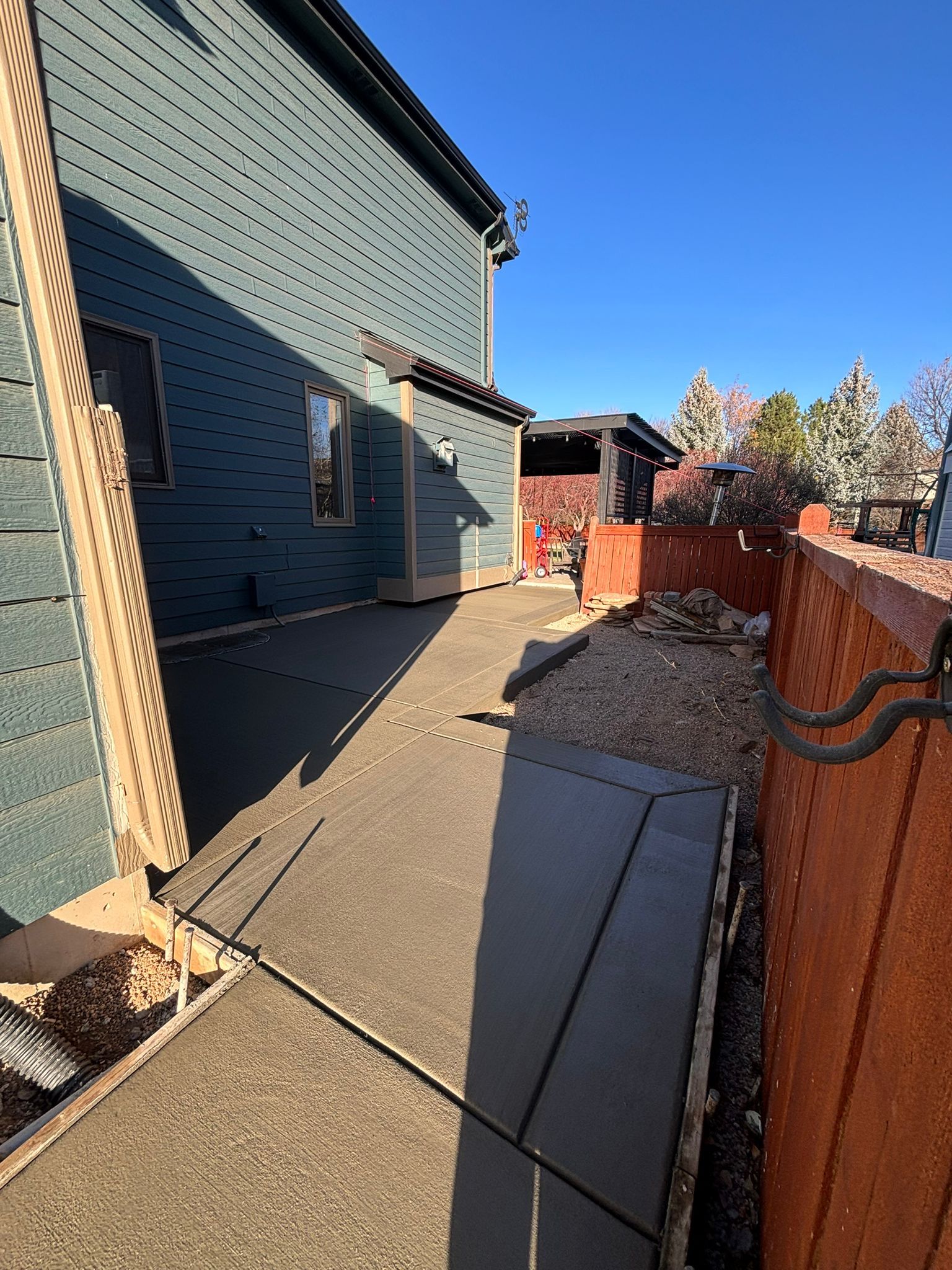 Newly finished concrete patio alongside a home in Fort Collins, Colorado