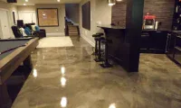 epoxy garage floors Stunning metallic epoxy basement floor installation in Fort Collins by Hugo's Concrete, featuring reflective bronze and copper tones with durable high-gloss finish