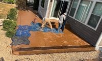 Homeowners working on a cheap DIY concrete patio project using stamped concrete design ideas for a backyard patio in Northern Colorado.