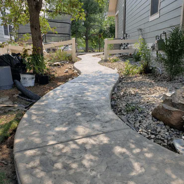 Concrete sidewalk at a residential property in Windsor, CO, with a durable and well-maintained finish.