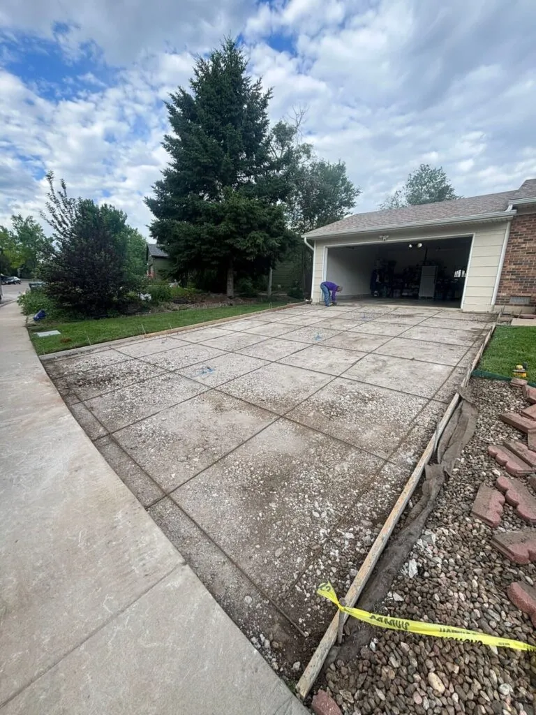 Old cracked concrete driveway in Fort Collins before replacement by Hugo’s Concrete on Hinsdale Drive