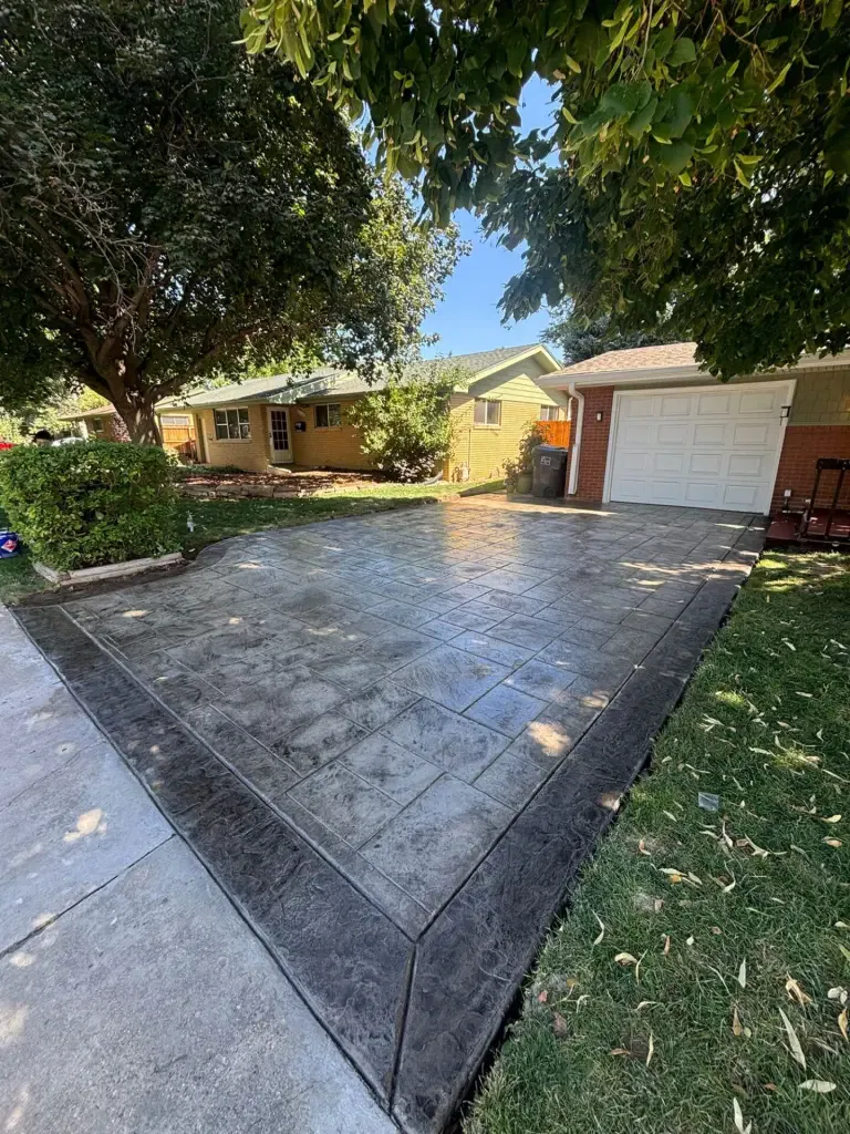 New concrete stamped driveway installed in Loveland, CO, smooth and durable residential driveway by Hugo’s Concrete.
