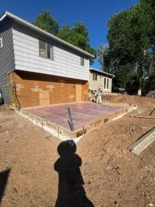 Home addition slab area prepped with compacted base, forms, and reinforcement ready for concrete pour in Fort Collins, CO