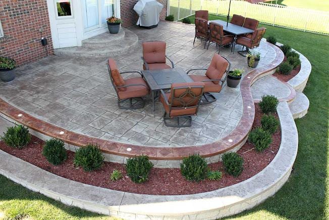 Stamped concrete patio with a colored border, featuring a decorative stone texture in Loveland, CO