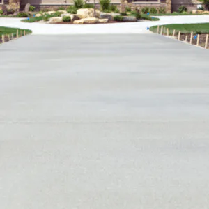 A freshly replaced, spacious, and beautifully finished concrete driveway in Loveland, CO, showcasing expert craftsmanship by Hugo’s Concrete.
