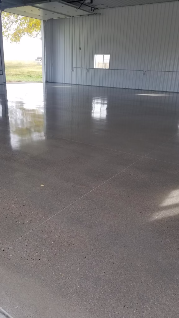 Polished concrete flooring in a spacious indoor area, showcasing a smooth, reflective surface in Windsor, CO