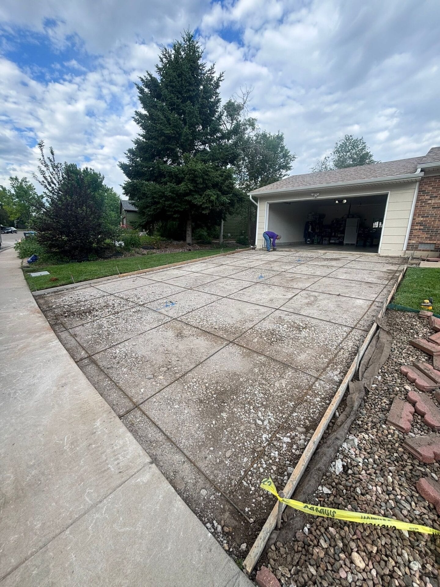 Old cracked concrete driveway in Fort Collins before replacement by Hugo’s Concrete on Hinsdale Drive