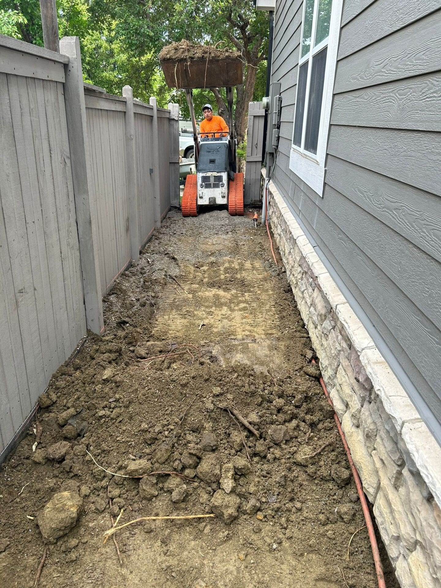 Excavated and compacted ground with rebar installed for new concrete sidewalk and walkway on Aruba Dr, Fort Collins, CO