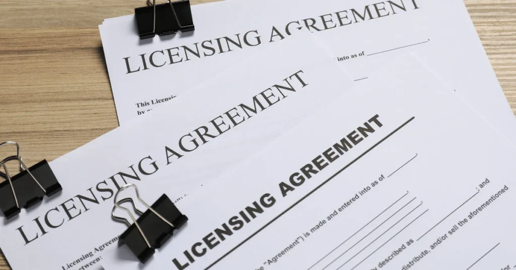 Close up of licensing agreement documents representing contractor licensing, insurance verification, and professional credentials before hiring a concrete contractor.