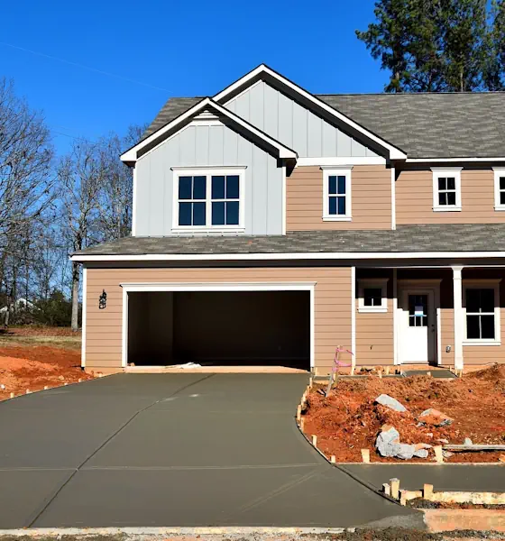New home with a freshly poured concrete driveway and sidewalk in Loveland, CO