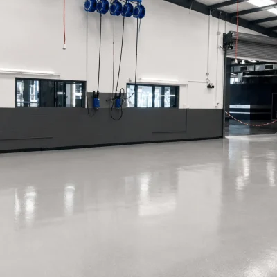 Modern commercial warehouse with professionally finished polished concrete flooring providing a durable, seamless surface for industrial and commercial spaces.