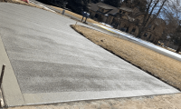 A freshly replaced, spacious, and beautifully finished concrete driveway in Loveland, CO, showcasing expert craftsmanship by Hugo’s Concrete.